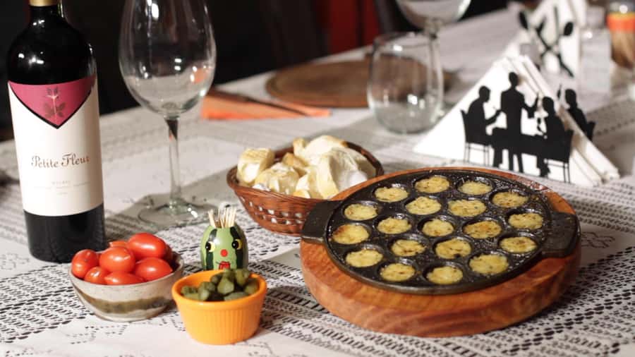 Secrets of Asado in Buenos Asado, BBQ and Dinner - Choripan on the grill, plus premium red wine